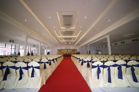 Pillarless banquet hall set with rows of seating and a red carpet aisle, Airport Road, Hyderabad