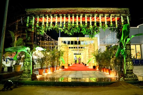 Yellow drape and floral photo backdrop at the venue entrance