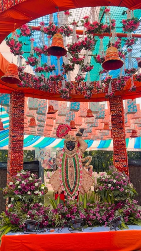 Floral shrine decor with hanging bells for a cultural event at Jaithri Grand