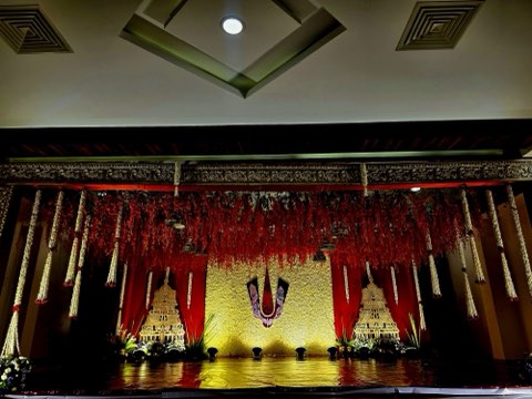Hall 2 – red and gold traditional stage with hanging marigold strings at Jaithri Grand Convention, Shamshabad