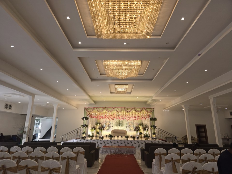 Main hall of Jaithri Grand Convention with chandeliers, guest seating and wedding stage, Airport Road, Hyderabad