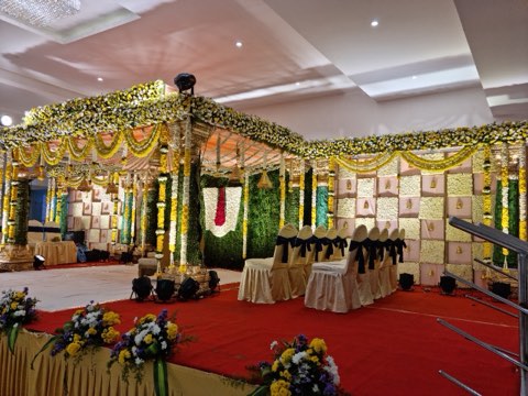Traditional South Indian wedding mandap with pink panelled backdrop at the wedding venue near Hyderabad airport