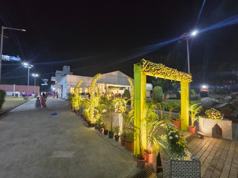 Decorated entrance path with greenery leading to the hall at night